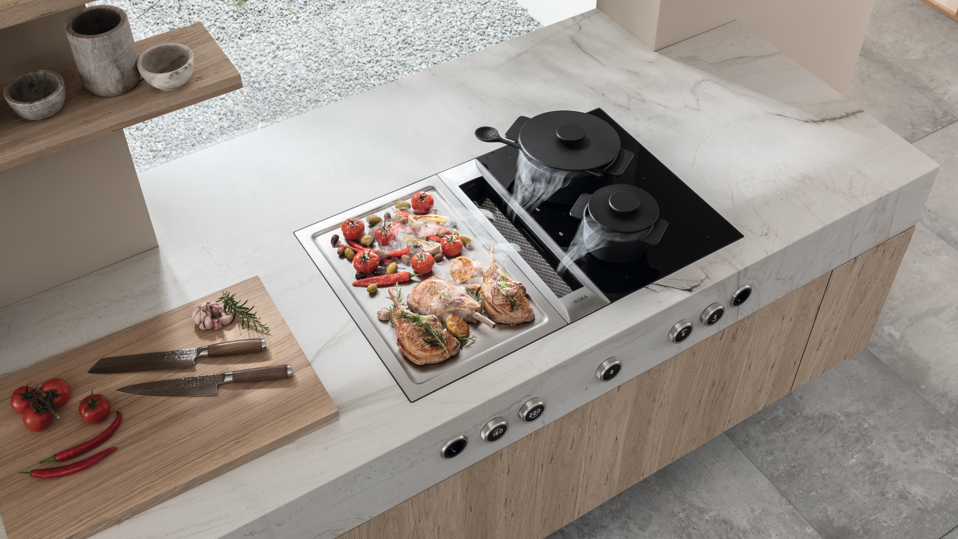 Système BORA Professional intégré dans un îlot central de cuisine sur mesure